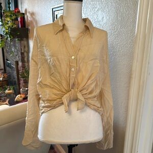 Amazing cream boutique blouse with sewn in place tie front NWOT!